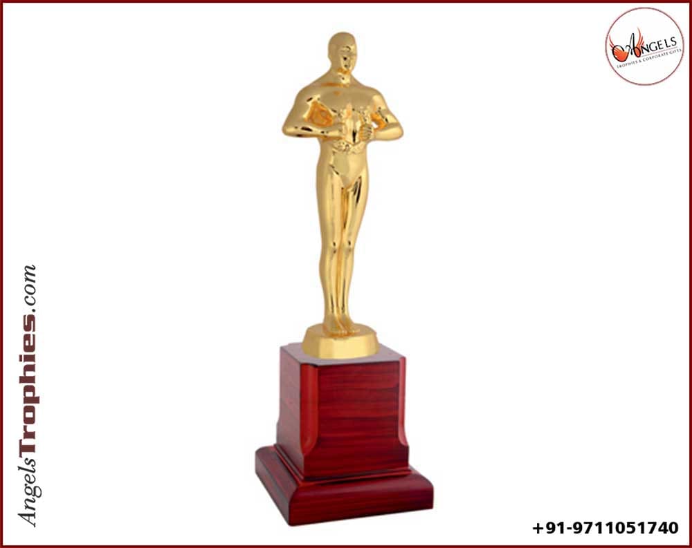 Metal oscar award trophy with wooden base