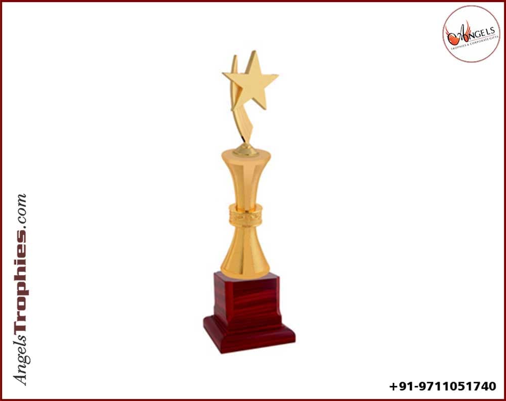 metal golden star with golden pillar with wooden base with award