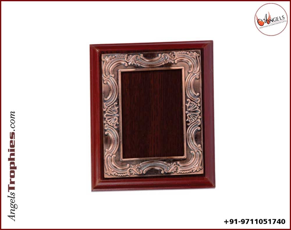 wooden award with bronze metal frame with award
