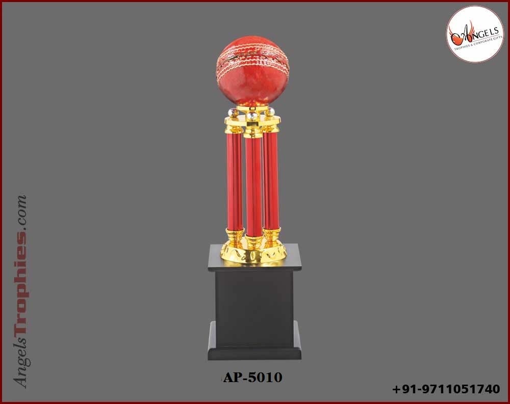 Metal red four pillor with cricket ball with wooden black base