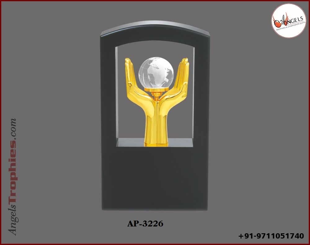 wooden window trophy with metal golden hand with globe