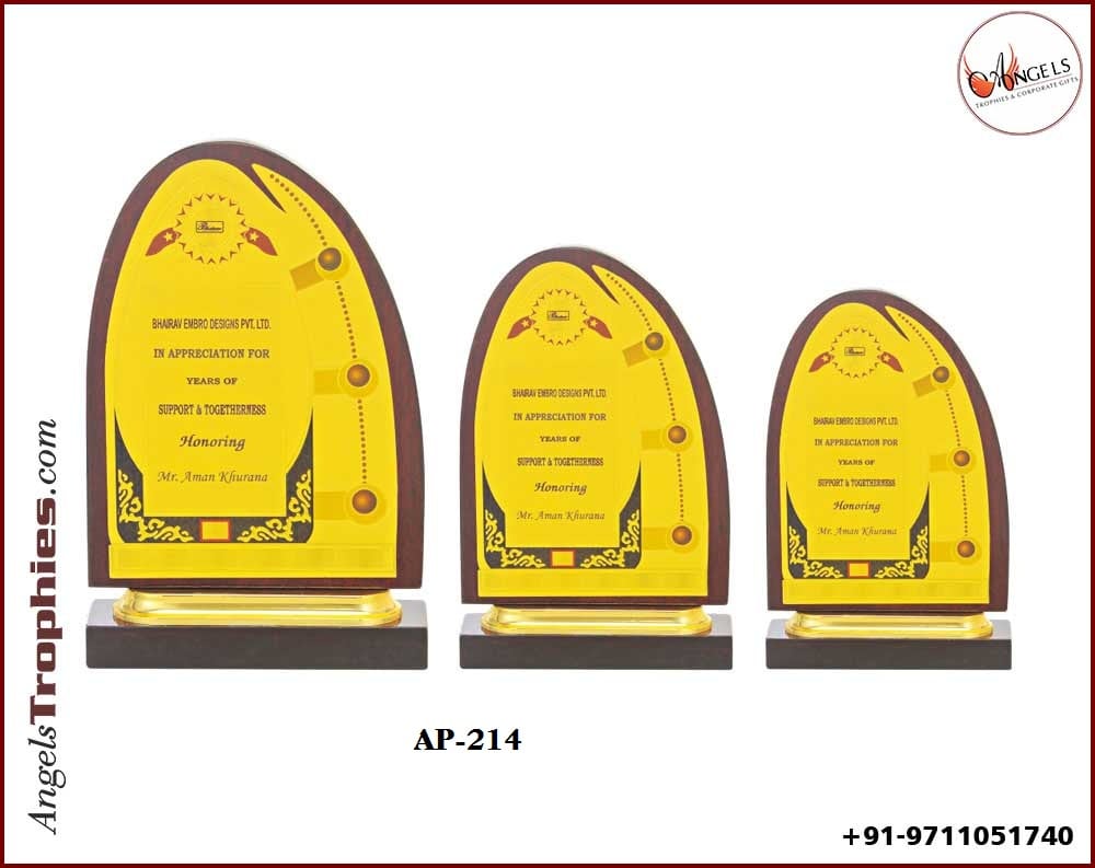 wooden award trophy with golden foil sheet with wooden base